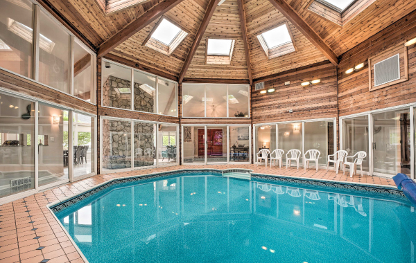 Image of an indoor pool with high ceilings and natural light